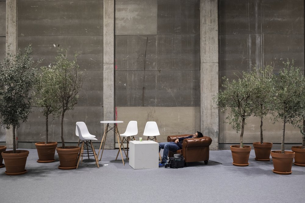 A visitor rests at the at the COP25 summit in Madrid, Sunday, 15 December 2019. Photo: Bernat Armangue / AP Photo