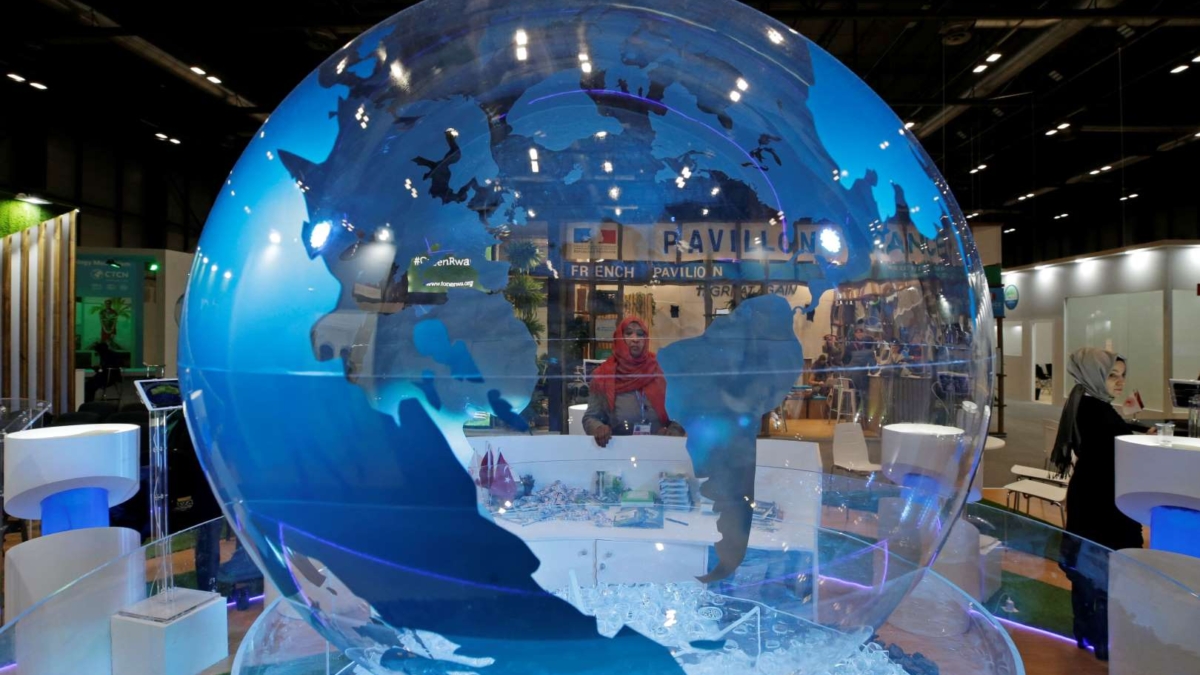 A woman looks at a World globe at the COP25 climate talks congress in Madrid, Spain, Friday, 13 December 2019. Officials from almost 200 countries scrambled to reach an agreement at a United Nations climate meeting amid growing concerns that key issues may be postponed for another year. Photo: Paul White / AP Photo