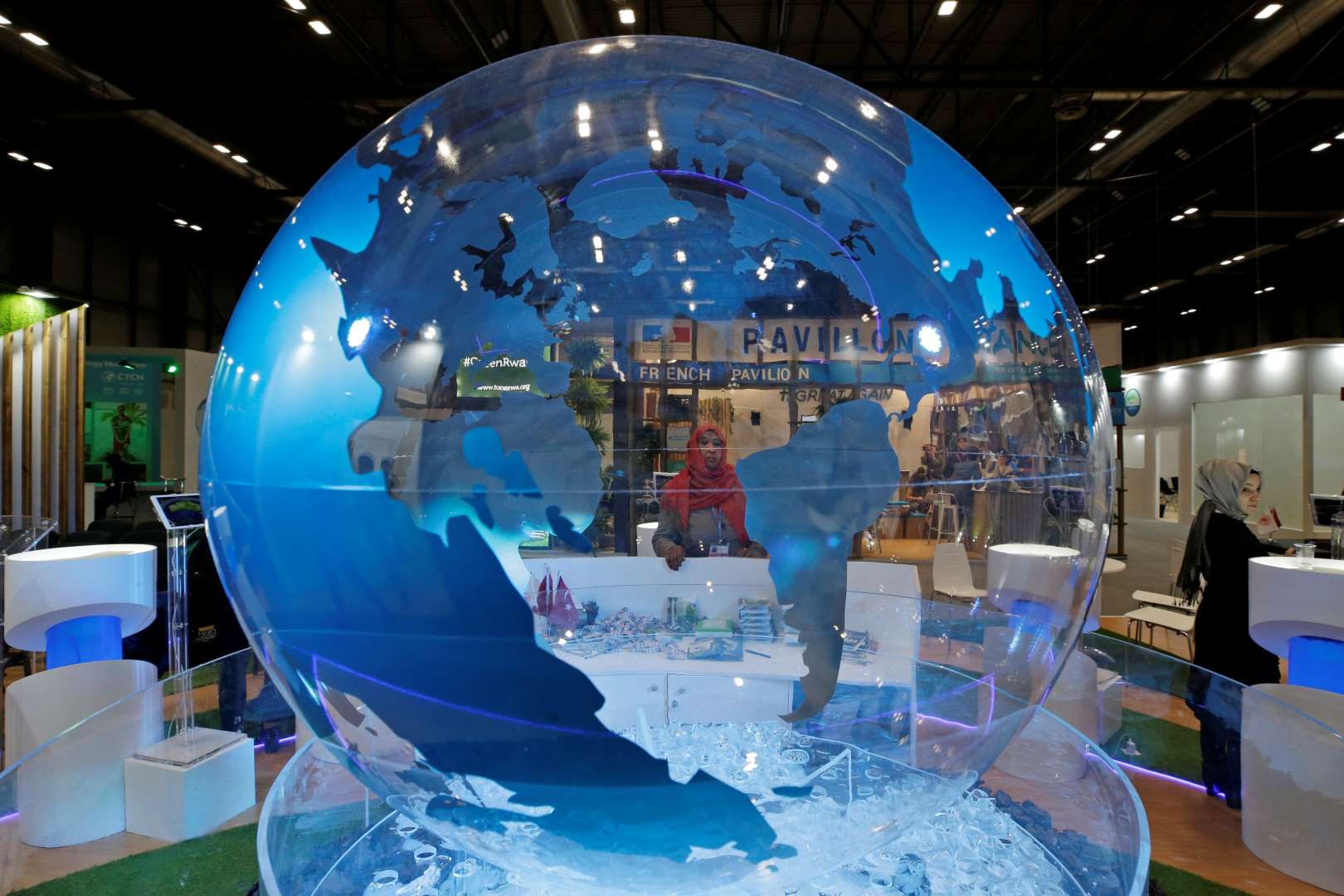A woman looks at a World globe at the COP25 climate talks congress in Madrid, Spain, Friday, 13 December 2019. Officials from almost 200 countries scrambled to reach an agreement at a United Nations climate meeting amid growing concerns that key issues may be postponed for another year. Photo: Paul White / AP Photo