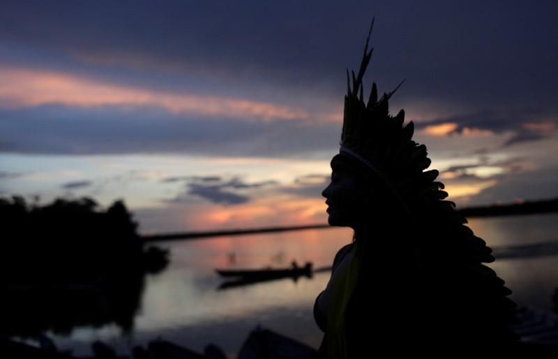 Indigenous leader of the Celia Xakriaba tribe walks next to the Xingu River during a four-day pow wow in Piaracu village, in Xingu Indigenous Park, near Sao Jose do Xingu, Mato Grosso state, Brazil, 15 January 2020. Photo: Ricardo Moraes / REUTERS