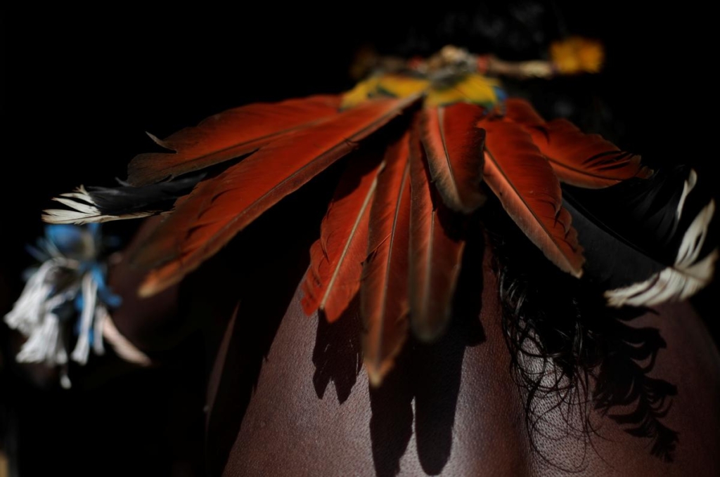 An indigenous man attends a meeting during a four-day pow wow in Piaracu village, in Xingu Indigenous Park, near Sao Jose do Xingu, Mato Grosso state, Brazil, 15 January 2020. Photo: Ricardo Moraes / REUTERS