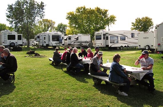 People eat at picnic tables at one of the Amazon CamperForce campgrounds. Photo: Amazon / Suzanne Greene / Pinterest