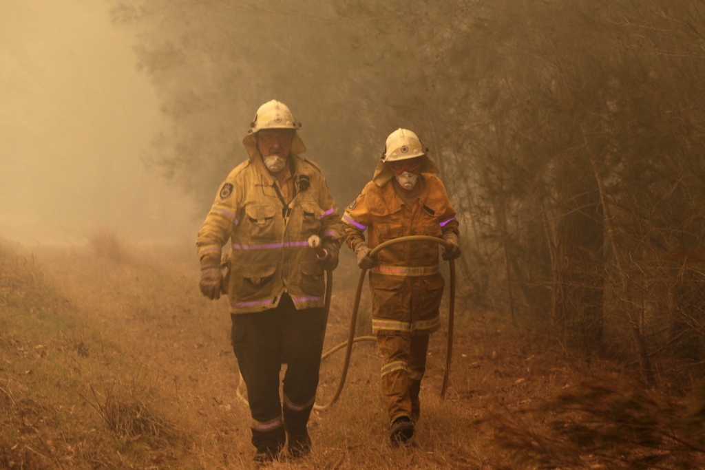 Firefighters near Moruya, on the south coast of New South Wales, on 4 January 2020. Photo: Rick Rycroft / AP