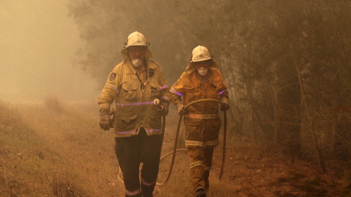 Firefighters near Moruya, on the south coast of New South Wales, on 4 January 2020. Photo: Rick Rycroft / AP