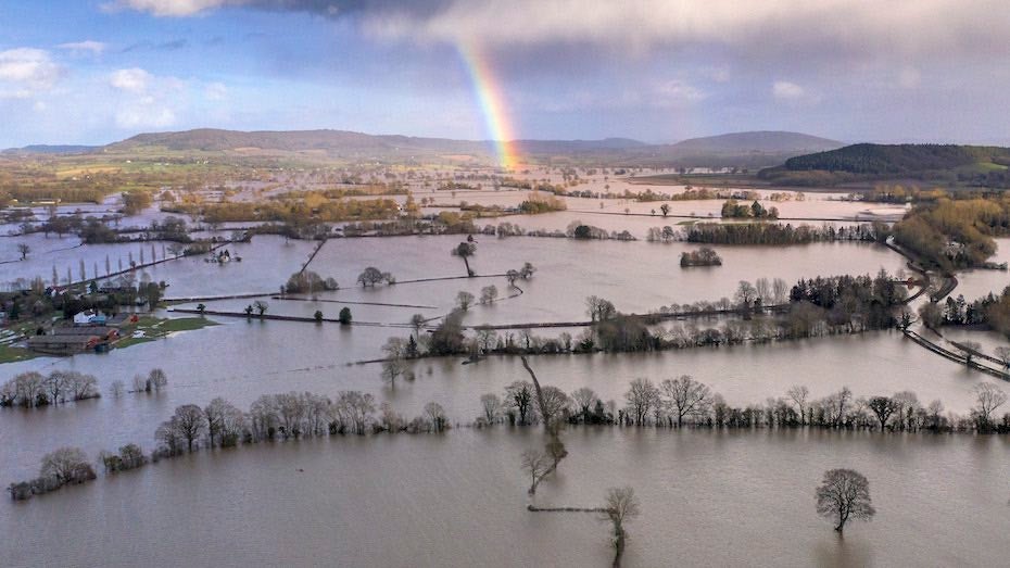 A rainbow appears over flooded fields in the Wye Valley, near the hamlet of Wellesley, in Hereford, England following Storm Dennis on 17 February 2020. Storm Dennis is the second named storm to bring extreme weather in a week, following Storm Ciara. Photo: Christopher Furlong / Getty Images