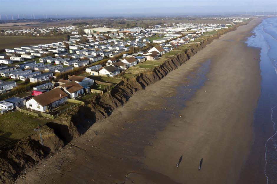 Aerial view of homes in Skipsea, East Yorkshire, UK endangered by encroaching coastal erosion. Photo: Owen Humphreys / PA Wire / PA