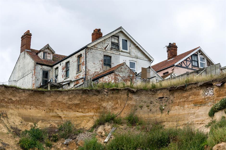 Coastal erosion encroaches on a house in Happisburgh, Norfolk, UK. Photo: Philip Bird, LRPS CPAGB / Shutterstock