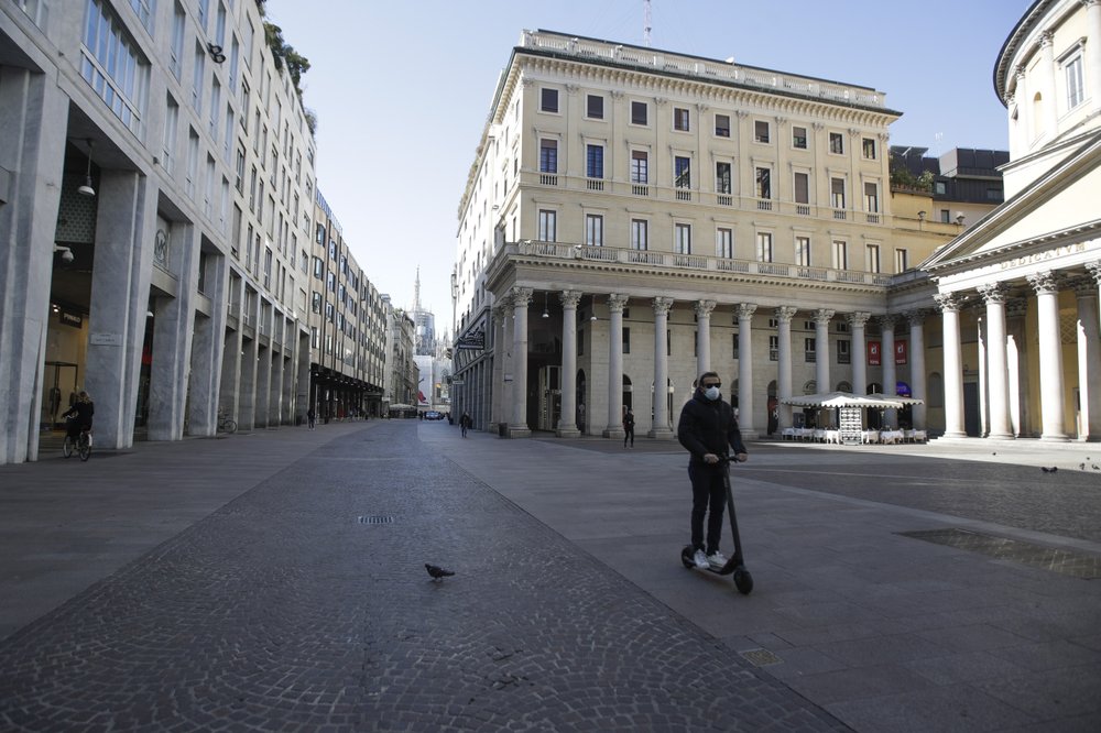 A man wearing a mask rides a scooter in Milan, Italy, Wednesday, 11 March 2020. Italy is mulling even tighter restrictions on daily life and has announced billions in financial relief to cushion economic shocks from the coronavirus. Photo: Luca Bruno / AP Photo