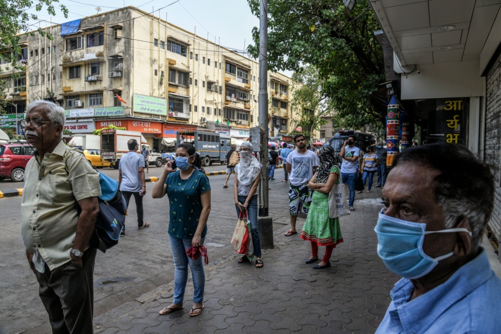 People in Mumbai, India wait in line to buy food on Wednesday, 25 March 2020. Photo: Atul Loke / The New York Times