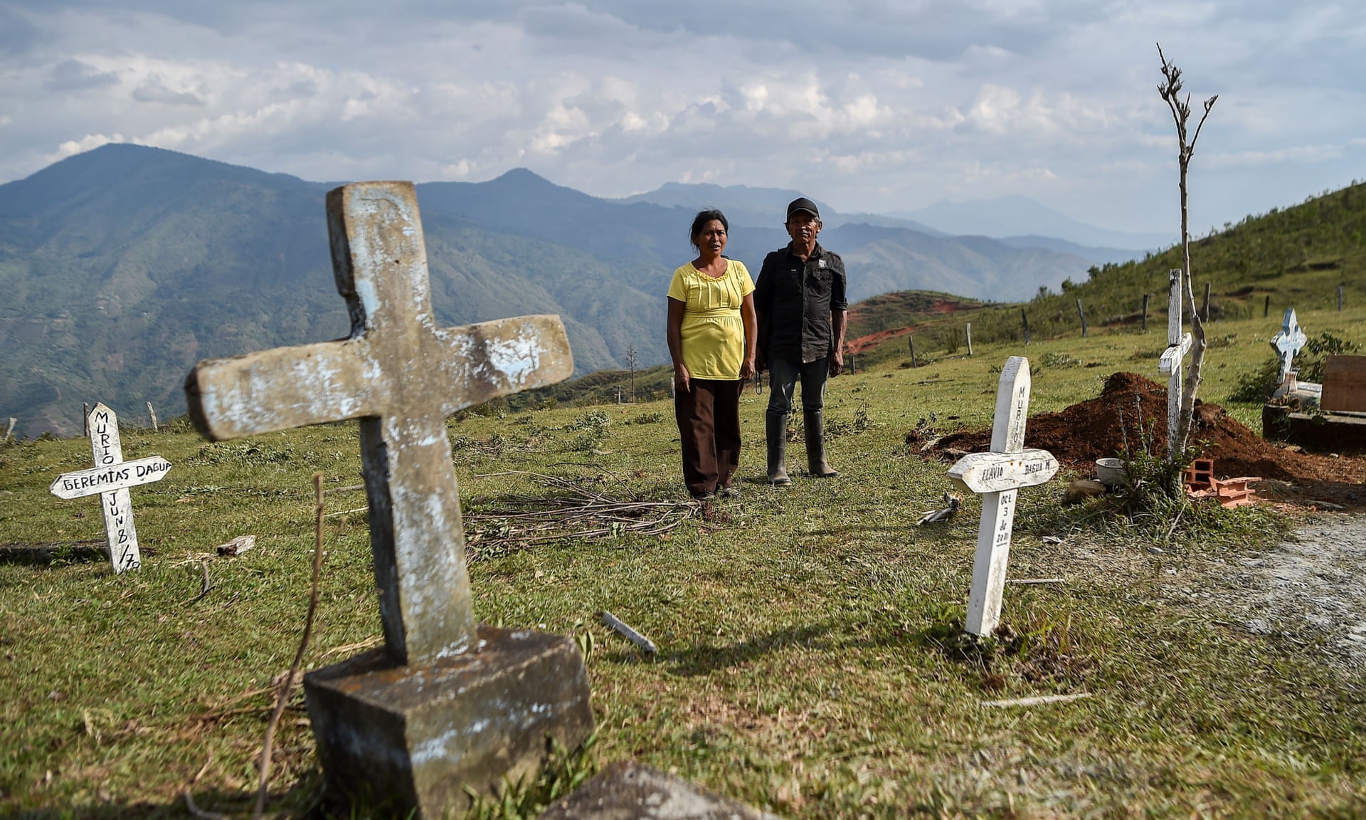 A woman and a man stand in a cemetery in Colombia. Three people have died and there are 277 cases in Colombia on 23 March 2020, as the local authorities impose restrictions. Death squads in Colombia are taking advantage of coronavirus lockdowns to murder rural activists, local NGOs have warned. Photo: Luis Robayo / AFP / Getty Images