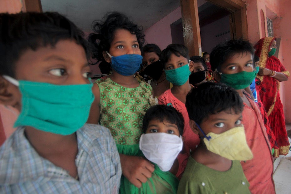 Evacuated children wearing masks as a precaution against the spread of coronavirus stand at a relief camp at Paradeep, on the Bay of Bengal coast in Orissa, India, Tuesday, 19 May 2020. Cyclone Amphan was moving toward India and Bangladesh on Tuesday as authorities tried to evacuate millions of people while maintaining social distancing. Photo: AP Photo