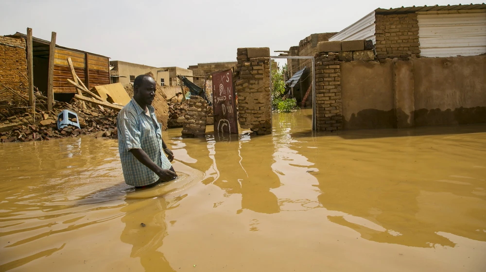 A man wades through the floodwaters in Khartoum, September 2020. Photo: Mahmoud Hjaj / Anadolu Agency / Getty Images