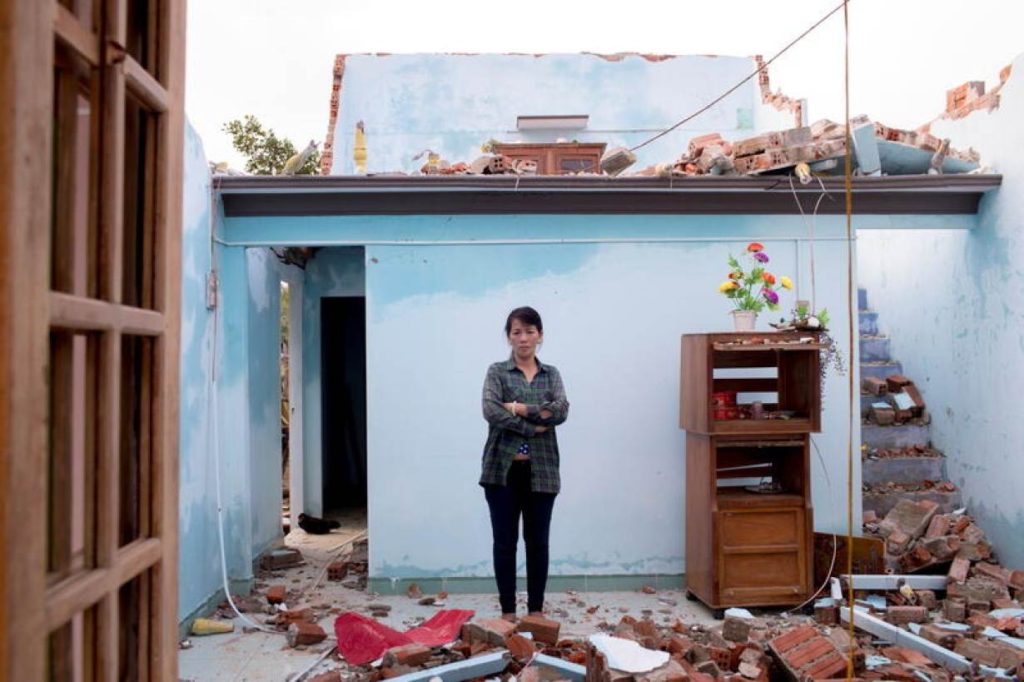 Typhoon Molave victim To Thi Cam, 51, stands in the ruins of her house in Quang Nam province, Vietnam, on 3 November 2020. Yen Duong / International Federation of the Red Cross (IFRC) / REUTERS