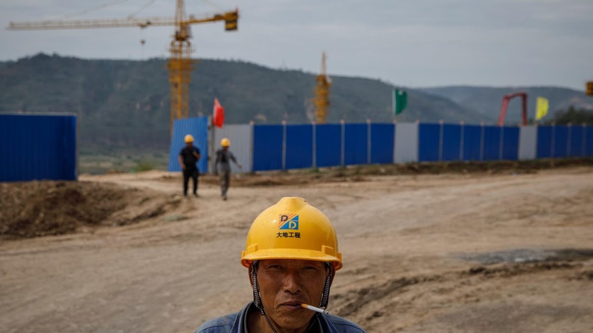 A worker stands outside a construction site of the Xinzhuang coal mine that is part of Huaneng Group’s integrated coal power project, on 30 September 2020. Photo: Thomas Peter / Reuters