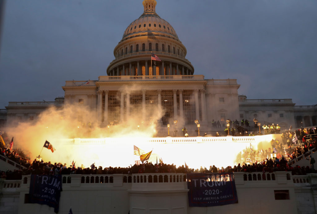 An explosion caused by a police munition is seen while Trump insurrectionists attack the U.S. Capitol Building in Washington, D.C., 6 January 2021. Leah Millis / REUTERS