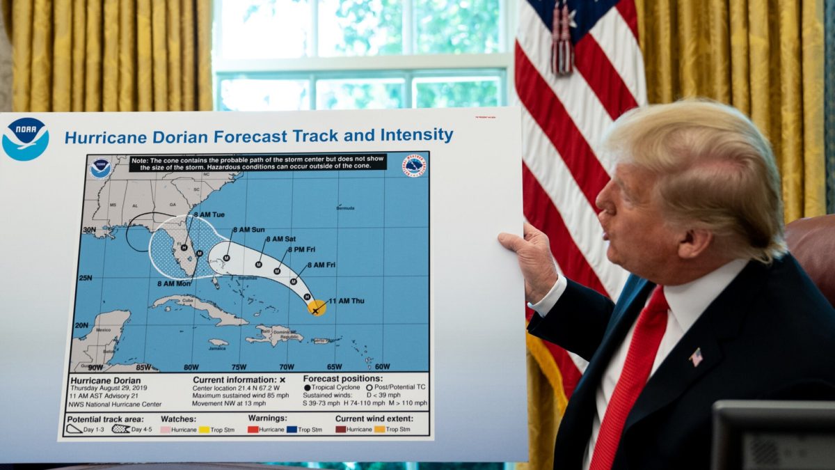 Trump refers to a map, modified using a Sharpie, while talking to reporters following a briefing from officials about Hurricane Dorian in the Oval Office at the White House on 4 September 2019. Trump has dismissed scientific evidence and fact numerous times, including 2019 when he displayed a map inaccurately modified to show Hurricane Dorian’s likely path. Photo: Erin Schaff / The New York Times