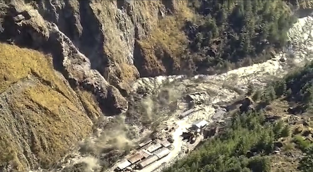 This frame grab from video provided by KK Productions shows a massive flood of water, mud, and debris flowing in the Chamoli District after a portion of the Nanda Devi glacier broke off in the Tapovan area of the northern state of Uttarakhand, India, Sunday, 7 February 2021. Photo: KK Productions / AP