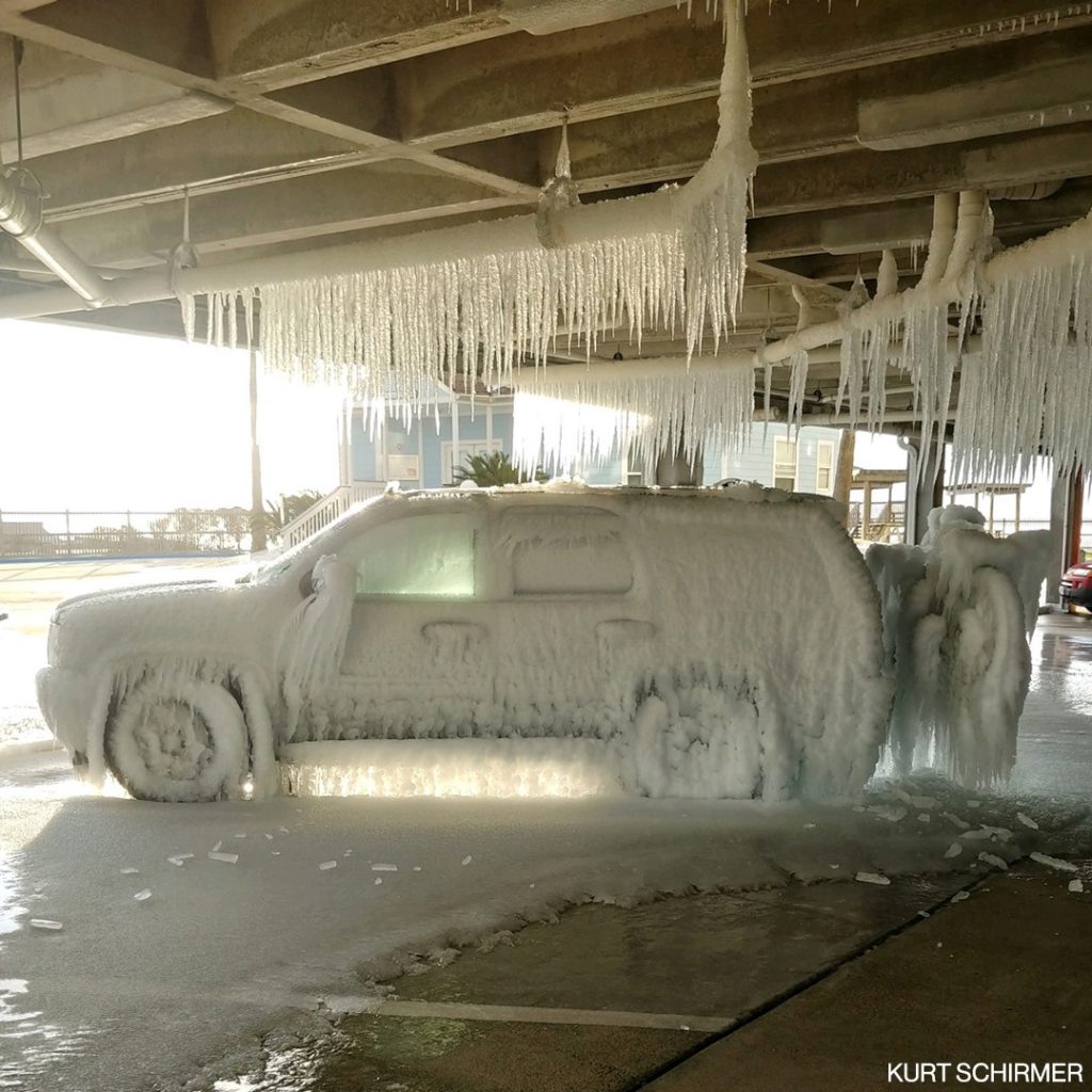 An SUV is frozen in ice after pipes burst inside a Galveston, Texas parking lot during devastating Winter Storm Uri, 18 February 2021. Photo: Kurt Schirmer