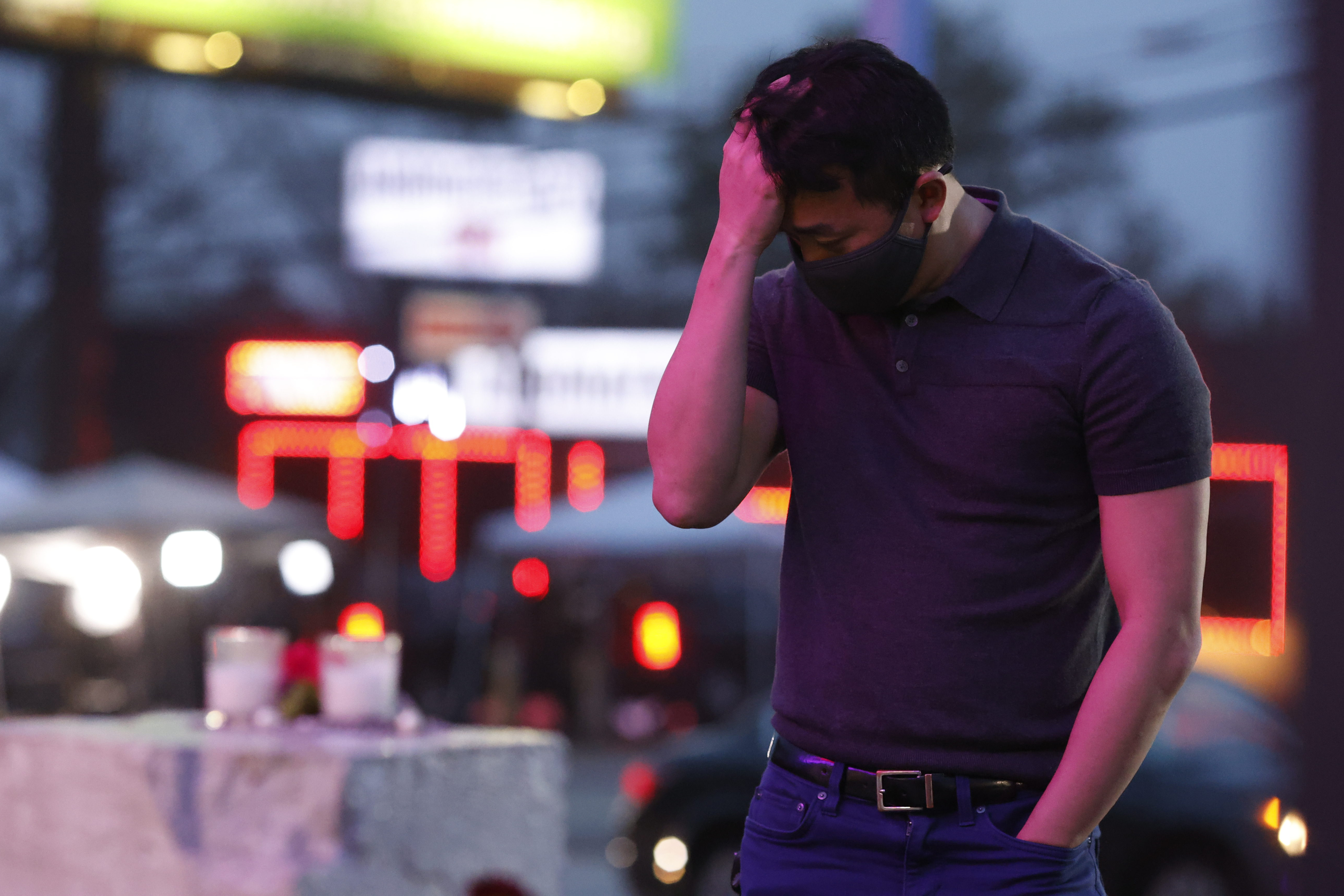 An Asian-American man who did not want to be identified pauses at a makeshift memorial on 17 March 2021 in front of Gold Spa, one of three spas in Georgia where Robert Aaron Long is accused of opened fire, killing eight people. Six of the victims were Asian-American women. Photo: Chris Aluka Berry / The Washington Post