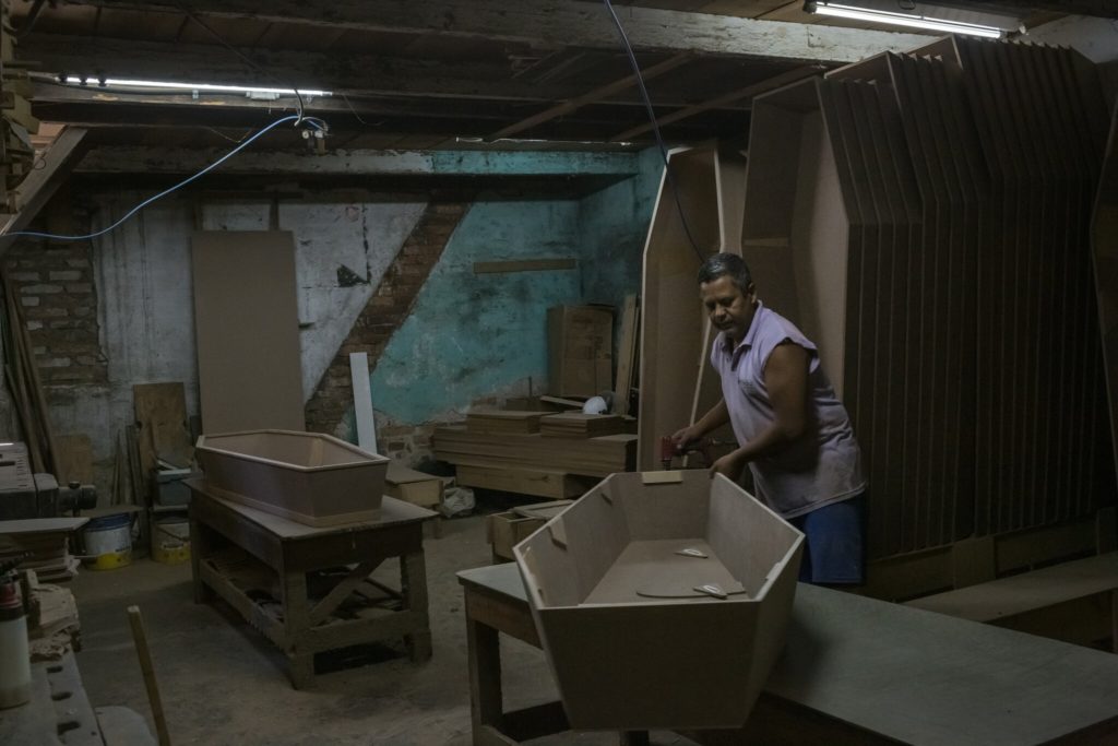 A coffin maker in Porto Alegre. Porto Alegre, a prosperous city in southern Brazil, is at the heart of an stunning breakdown of the country’s health care system in March 2021, as the Covid-19 pandemic spreads unchecked. Photo: Mauricio Lima / The New York Times