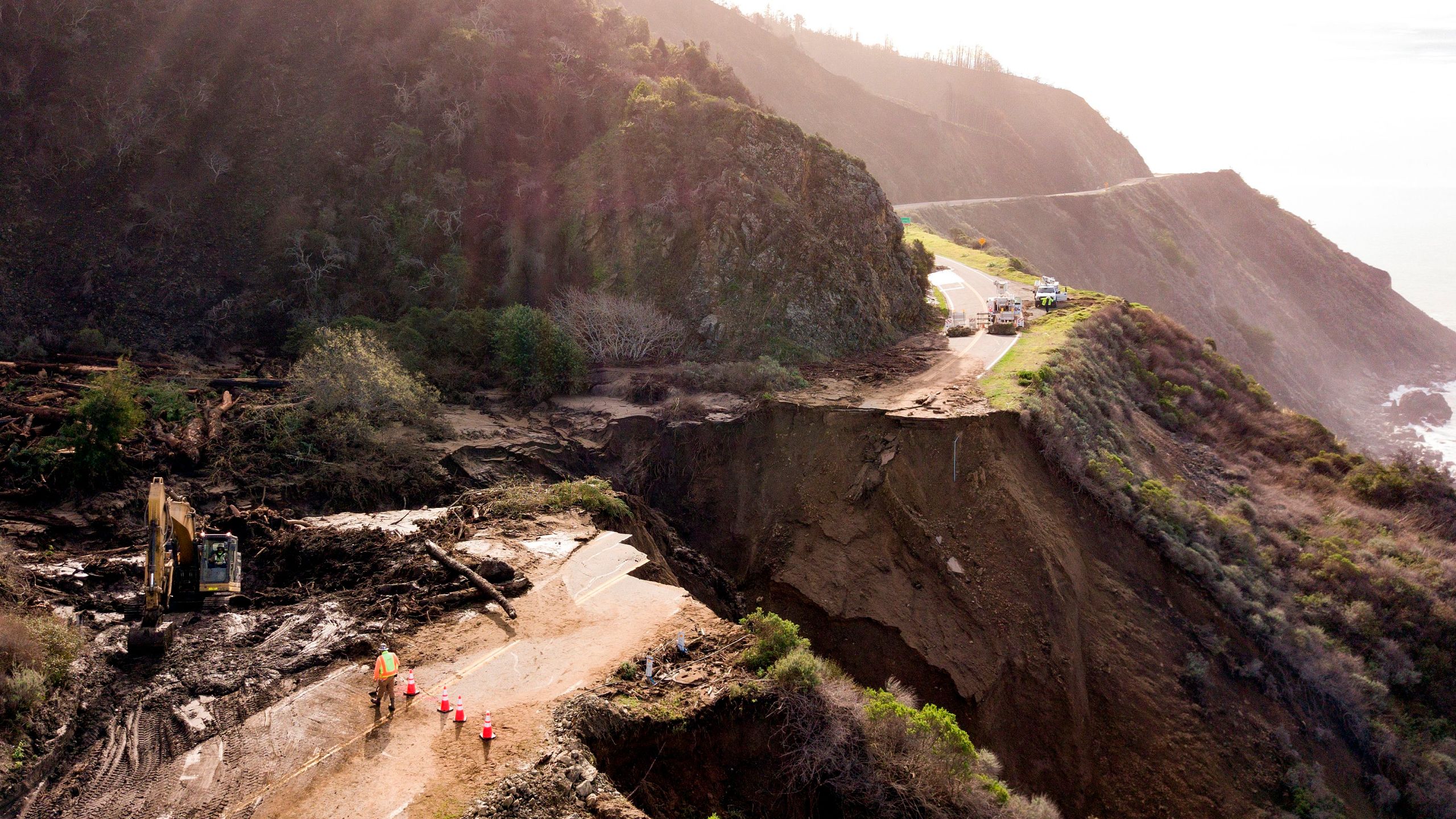 Construction crews work on a section of Highway 1 which collapsed into the Pacific Ocean near Big Sur, California on 31 January 2021. Heavy rains caused debris flows of trees, boulders, and mud that washed out a 150-foot section of the road. Photo: Josh Edelson / AFP / Getty Images