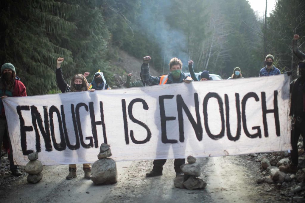 Forest defenders block a logging road to oppose the cutting of old growth trees in the Caycuse watershed on southern Vancouver Island in April 2021. Photo: Jesse Winter / The Guardian