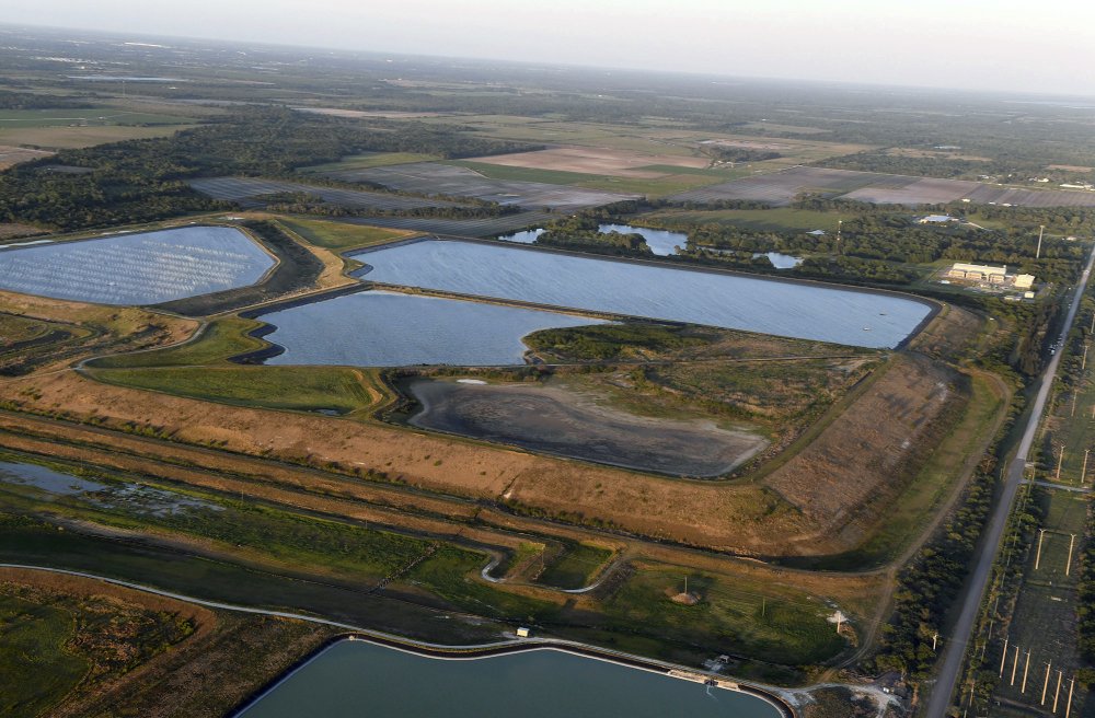 Aerial photo of a reservoir near the old Piney Point phosphate mine, 3 April 2021 in Bradenton, Florida. Florida Gov. Ron DeSantis declared a state of emergency Saturday after a significant leak at a large pond of wastewater threatened to flood roads and burst a system that stores polluted waters. The pond where the leak was discovered is at the old Piney Point phosphate mine, sitting in a stack of phosphogypsum, a waste product from manufacturing fertilizer that is radioactive. Photo: Tiffany Tompkins / The Bradenton Herald / AP