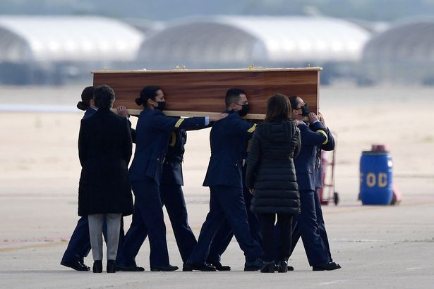 Spanish air force personnel carry the coffins with bodies of Spanish journalists David Beriain and Roberto Fraile and an Irish ONG chief Rory Young killed by JNIM (Groupe de soutien à l’islam et aux musulmans) insurgents in eastern Burkina Faso, after landing at the Torrejon de Ardoz air base on 30 April 2021. Photo: Javier Soriano / AFP / Getty Images