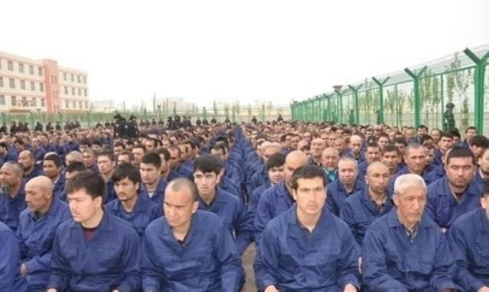 Uyghur men imprisoned at the Lop County #4 Re-Education Camp, Xinjiang, China. They are forced to listen to “de-radicalization” lectures. Photo: Weixin