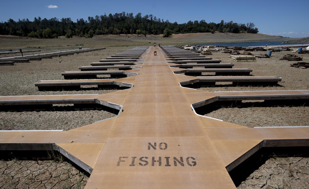 Empty boat docks sit on dry land at the Browns Ravine Cove area of drought-stricken Folsom Lake, currently at 37 percent of its normal capacity, in Folsom, California on 22 May 2021. California Gov. Gavin Newsom declared a drought emergency for most of the state. Photo: Josh Edelson / AP Photo