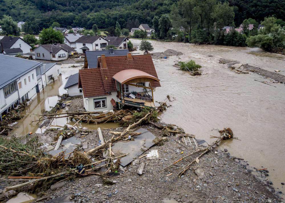 A damaged house is seen at the Ahr river in Insul, western Germany, 15 July 2021. Due to record rainfall the Ahr river dramatically went over the banks the evening before. At least 42 people died after record rainfall caused heavy flooding and turned streams and streets into raging torrents, sweeping away cars and causing some buildings to collapse. Photo: Michael Probst / AP Photo