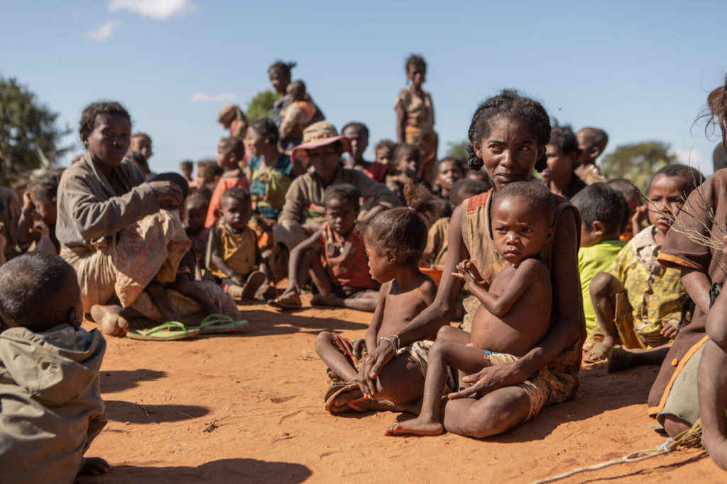 Families suffering from acute malnutrition gather for food aid in Ankao, Ambondro, Ambovombe, Madagascar, on  11 June 2021. Southern Madagascar is experiencing its worst drought in four decades with more than 1.14 million people food insecure. Of those, an estimated 14,000 people were in catastrophic conditions (IPC Phase 5) by June 2021. Children under five are among the most affected by malnutrition in southern Madagascar. Photo: Tsiory Andriantsoarana / WFP