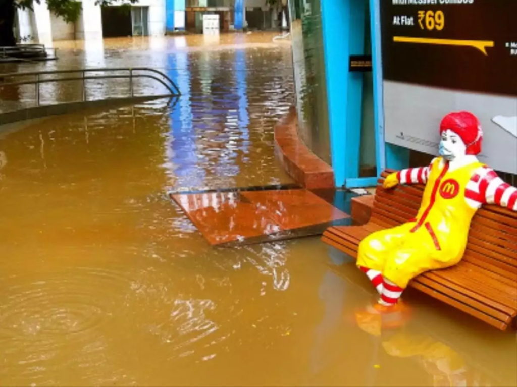Floodwaters rise around the legs of a Ronald McDonald sculpture in Mumbai, 22 July 2021. Photo: BCCL / Times of India
