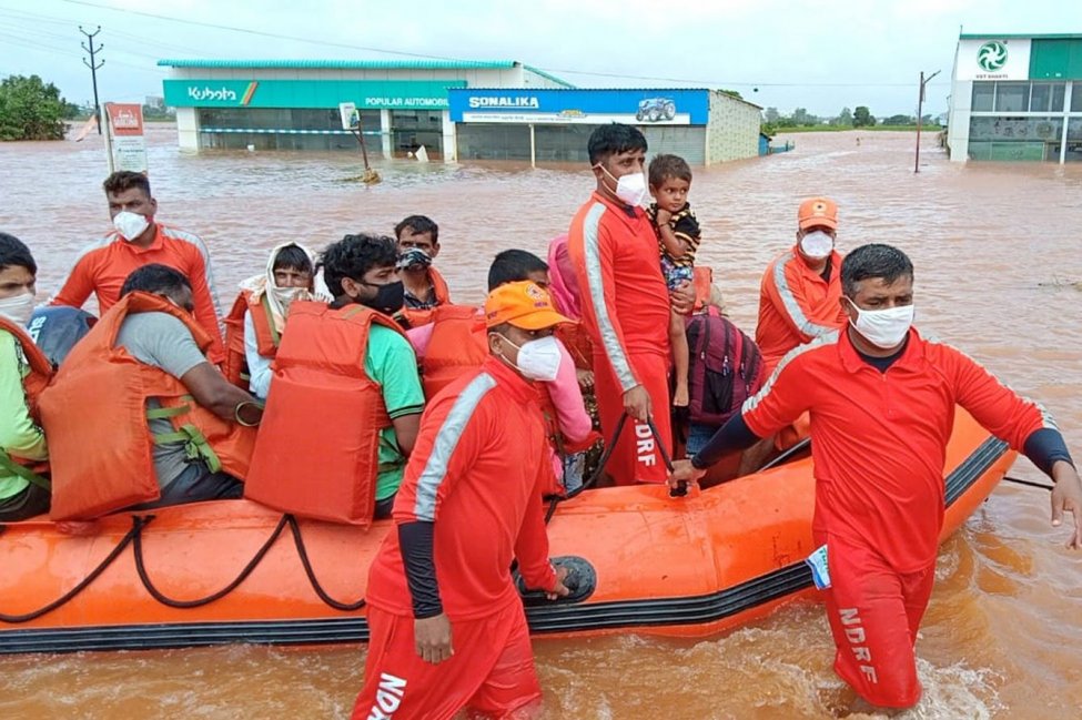 Indian National Disaster Response Force personnel rescue people from areas inundated with floodwaters on 26 July 2021 in Maharashtra state, India. Photo: National Disaster Response Force / EPA-EFE