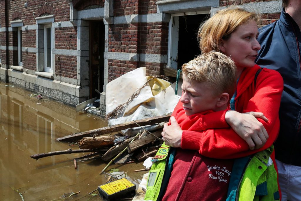 Madeline Brasseur, 37, embraces her son Samuel, 12, at an area affected by floods, following record rainfalls, in Pepinster, Belgium, 17 July 2021. Photo: Yves Herman / REUTERS