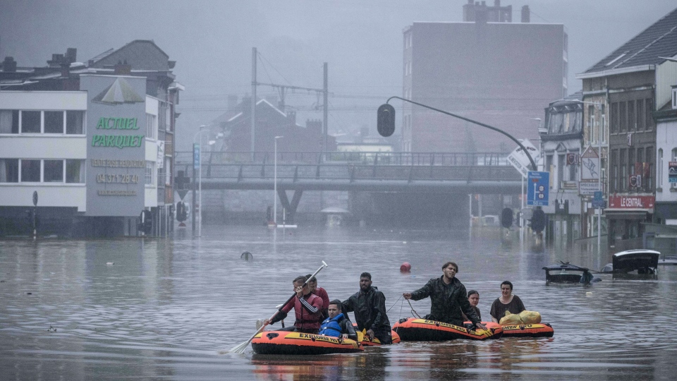 People use rubber rafts in floodwaters after the Meuse River broke its banks during heavy flooding in Liege, Belgium, Thursday, 15 July 2021. Photo: Valentin Bianchi / AP Photo