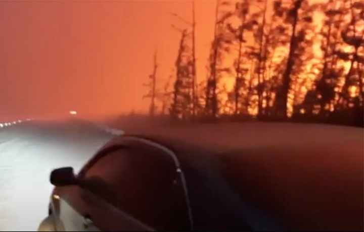A wildfire rages beside the Kolyma highway, 30 June 2021. The highway is the major connection between the Republic of Sakha’s capital Yakutsk and the port town of Magadan, on the Sea of Okhotsk. The highway had to be shut because the fire got too close to the road and was much too fierce for safe driving. Photo: The Siberian Times