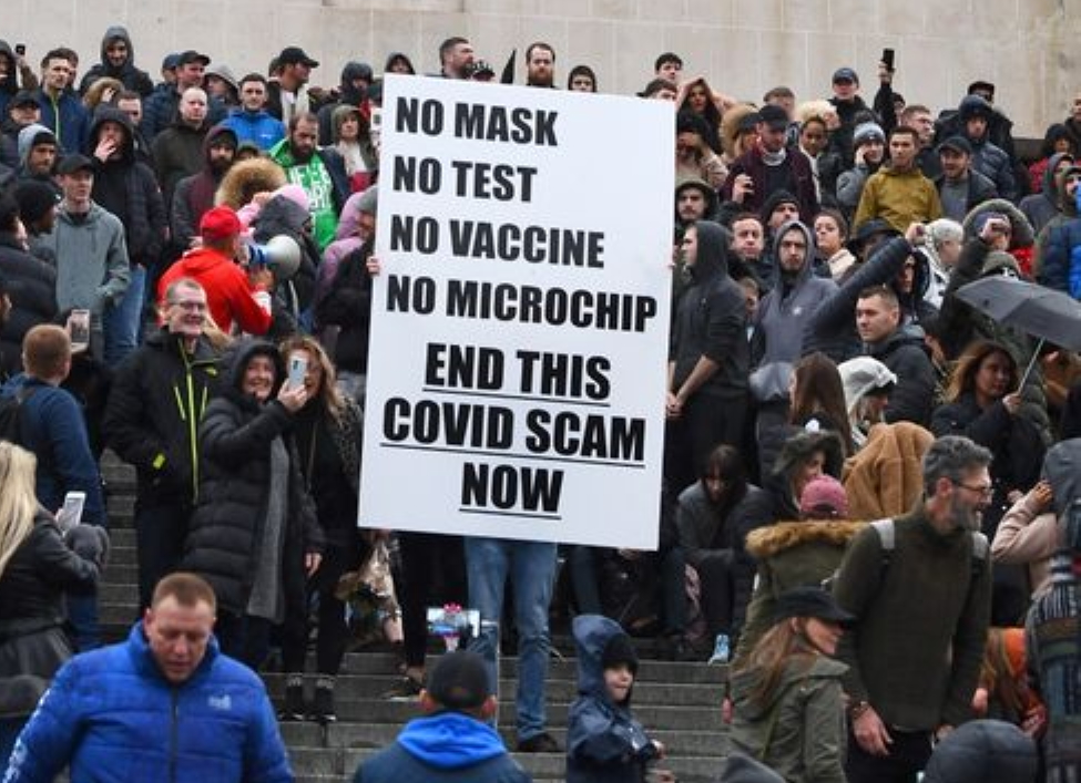 Anti-vaccine protesters with no masks gather on the steps of the Metropolitan Cathedral in Liverpool, England on 14 November 2020. One protester holds a sign that reads, “No mask - No test - No vaccine - No microchip - End this Covid scam now”. A man was arrested after a police officer was assaulted and a woman was arrested on suspicion of attempted Section 18 wounding and dangerous driving. Merseyside Police said in total, 27 people were arrested of which 25 were for public order offences and breaches of Coronavirus legislation and 17 people were served with fixed penalty notices. Photo: Andy Teebay / Liverpool ECHO