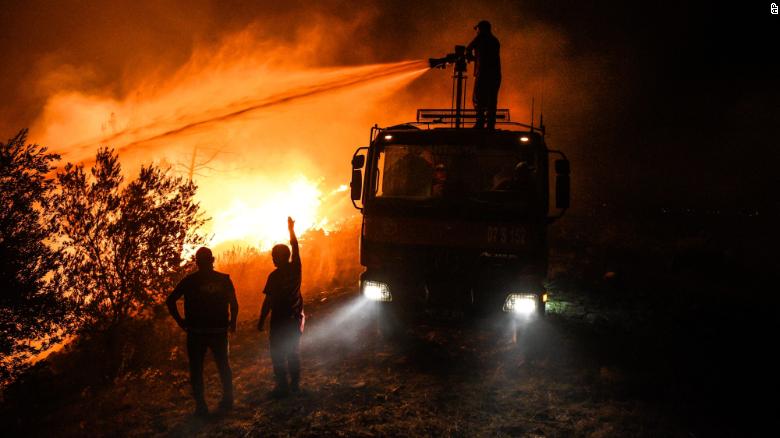 Firefighters try to get a wildfire under control in Kirli village near the town of Manavgat, in Antalya province, Turkey, early Friday, 30 July 2021. Photo: AP Photo