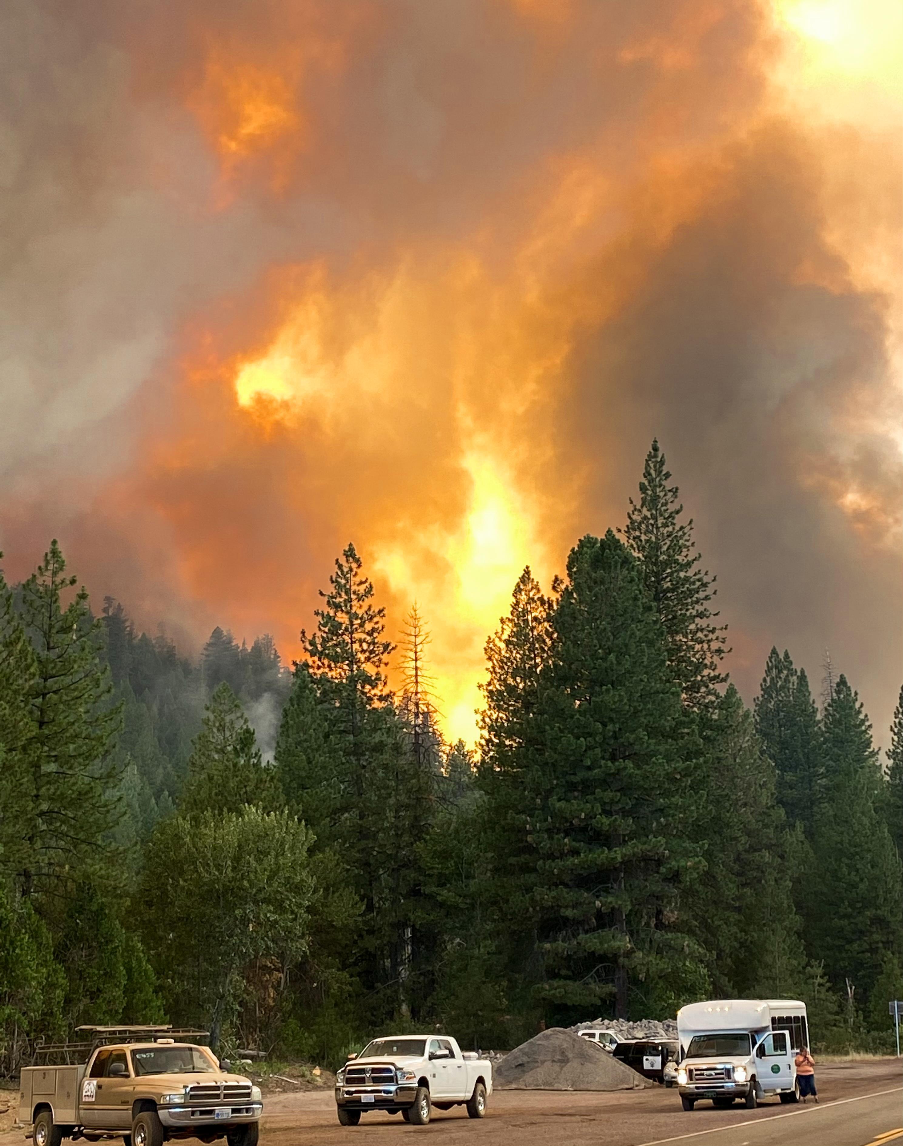 Smoke and flames from the Dixie fire are seen from Wolf Creek Road west of Greenville, California, 4 August 2021. Photo: InciWeb