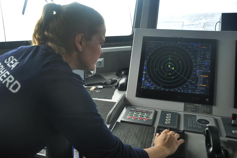 Carmen McGregor, second officer of the Ocean Warrior, checks the radar system on 18 July 2021, as part of the ship’s 18-day voyage to observe up close the activities of the Chinese distant water fishing fleet off the west coast of South America. Photo: AP Photo / Joshua Goodman