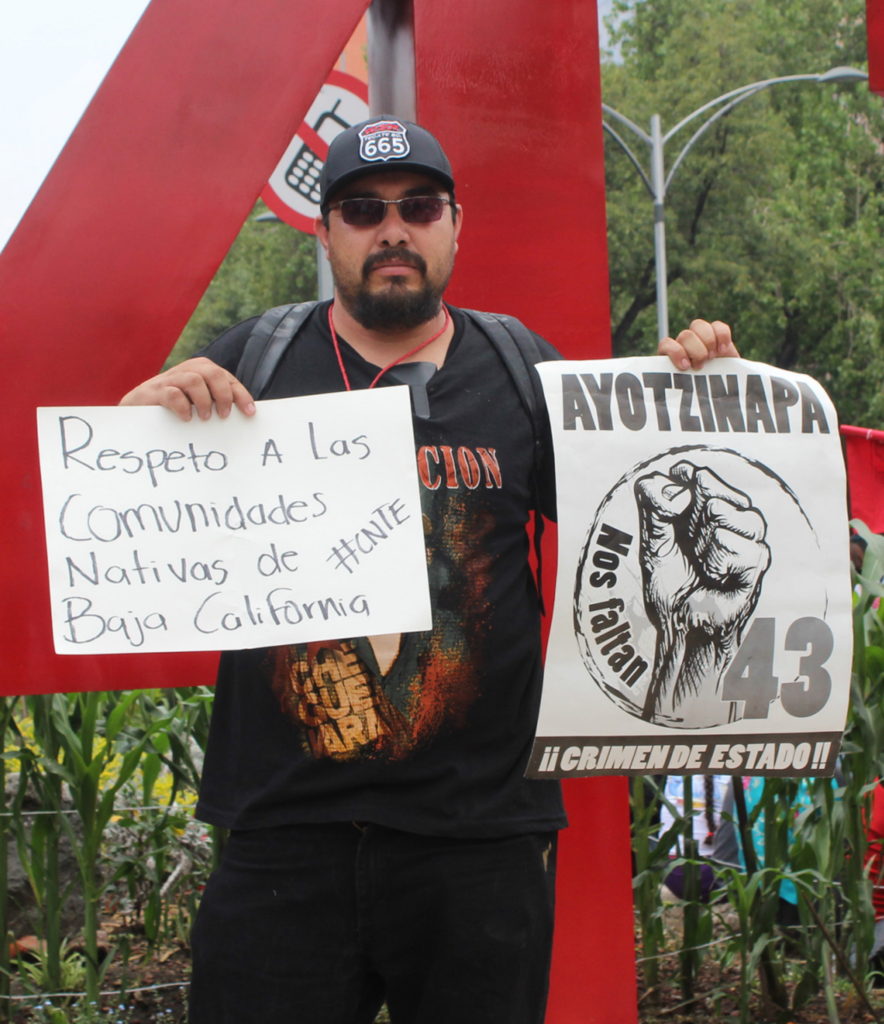 Óscar Eyraud Adams holds a sign calling for respect for the indigenous communities of Baja California. He was murdered in Tecate on 24 September 2020 for defending indigenous water rights in the Kumiai territory. Photo: Mexicali Resiste
