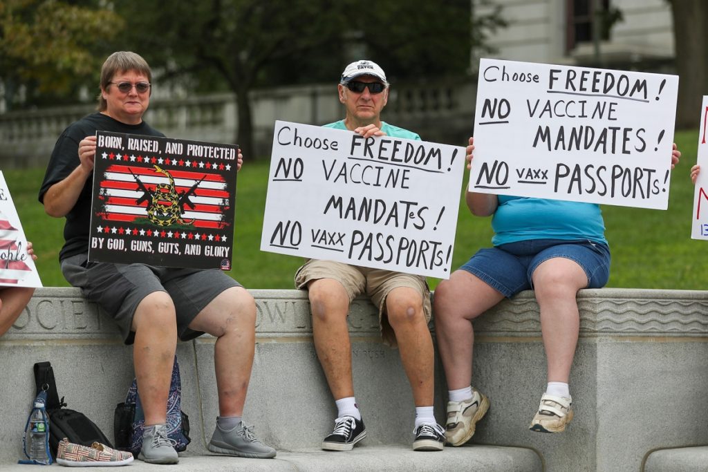 Maskless anti-vaccine protesters hold signs on the steps of the Pennsylvania State Capitol during the Rally for Freedom in Harrisburg, Pennsylvania on 29 August 2021. Photo: Paul Weaver / Sipa USA / AP Images