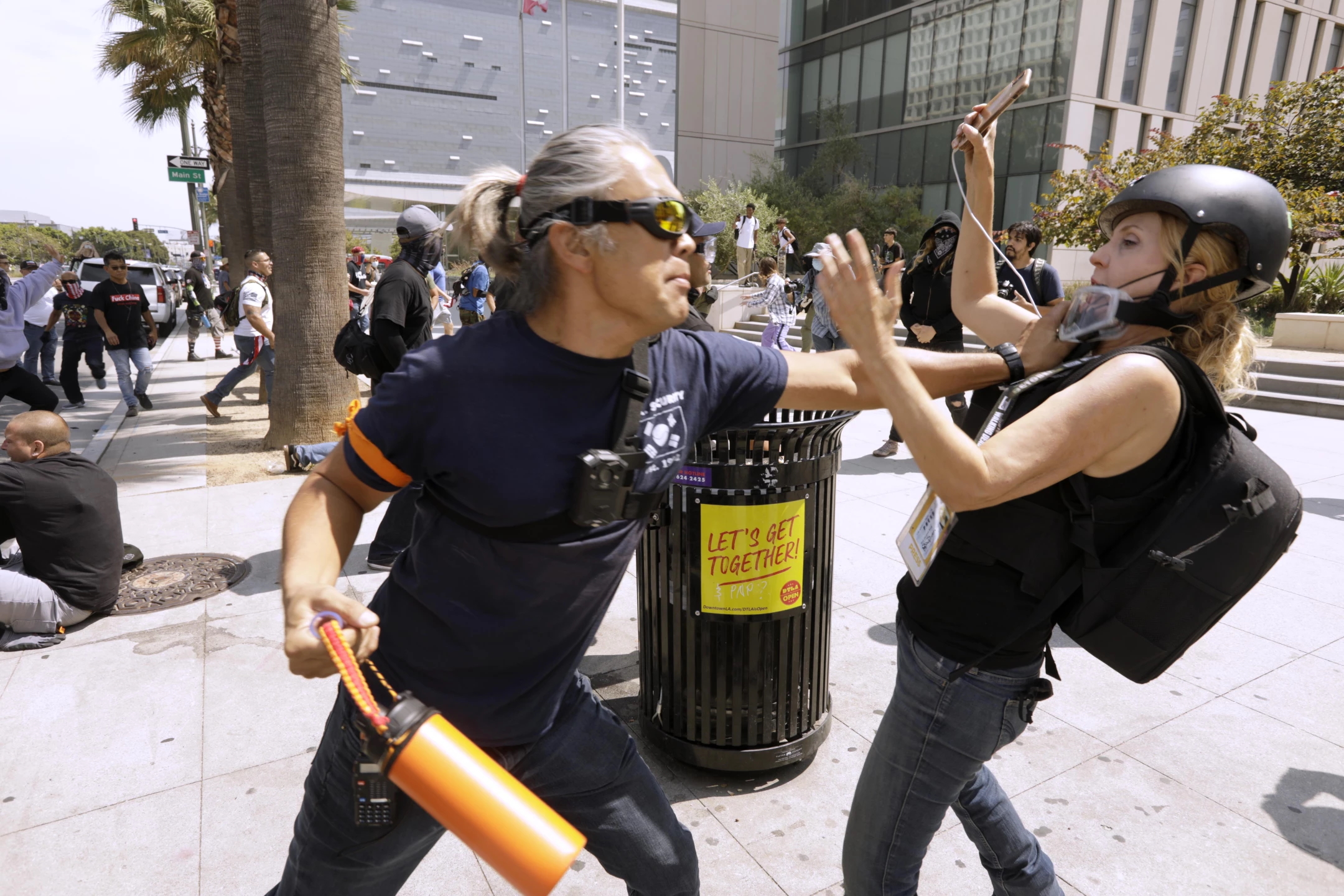 An anti-vaccine protester, left, attacks Status Coup journalist Tina Desiree Berg at an anti-vaxxer protest in Los Angeles on 14 August 2021. During the protest, one man screamed, “unmask them all” and clawed at a woman’s face. KPCC reporter Frank Stoltze walked out of the park near City Hall at was screamed at by anti-mask protesters. One man could be seen kicking him. Stoltze later told a police officer he had been assaulted while trying to conduct an interview. Stoltze later tweeted this statement: “Something happened to me today that’s never happened in 30 yrs of reporting. In LA. I was shoved, kicked and my eyeglasses were ripped off of my face by a group of guys at a protest - outside City Hall during an anti-vax Recall @GavinNewsom/Pro Trump rally.” Photo: Genaro Molina / Los Angeles Times
