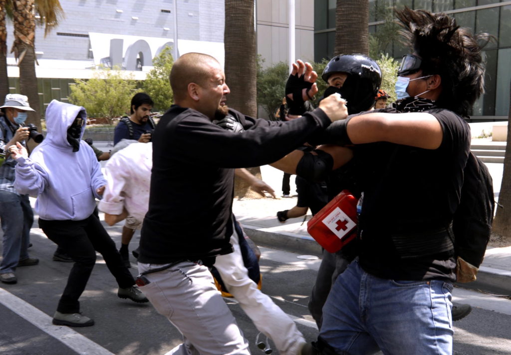 An anti-vaxxer confronts a pair of vaccine advocates in front of LAPD headquarters on 14 August 2021, during a protest that turned violent. Los Angeles City Council President Nury Martinez decried the violence in a tweet. “These aren’t ‘patriots’. Not wearing a mask and being anti-vax isn’t patriotism - it’s stupidity,” she said. “We have to be able to have differences of opinions without resorting to violence.” Photo: Genaro Molina / Los Angeles Times