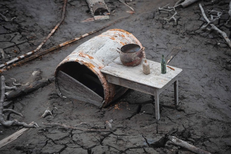 Bottles stand where they were left on a table when the village of Aceredo, in Galicia, Spain was inundated by the Lindoso Reservoir was filled in 1992, creating an eerie scene 22 November 2021. Photo: Miguel Riopa / AFP