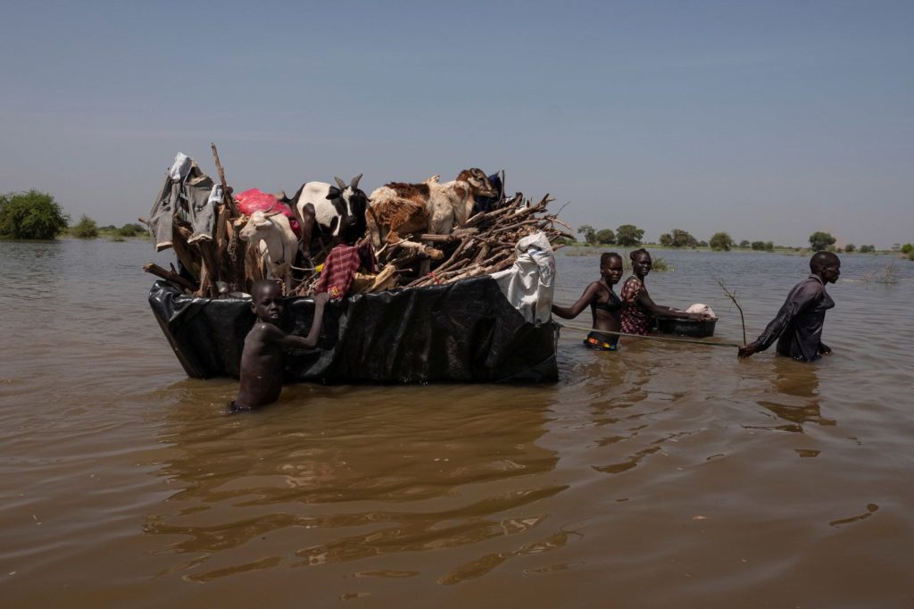 A South Sudan family pulls their possessions and livestock on a homemade raft after record flooding in November 2021. Photographer Sebastian Rich met this family after they had traveled 20 kilometers (about 12.4 miles). They were tired and hungry, Rich said, and the father in the family told him: “Only 5 kilometers (3.1 miles) to go.” Photo: Sebastian Rich / UNICEF