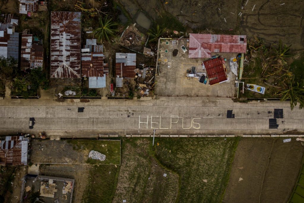 Aerial view of destruction in the Philippines after Super Typhoon Rai, 27 December 2021. “Help Us” was scrawled on a road in Alicia, Bohol Province. Photo: The New York Times
