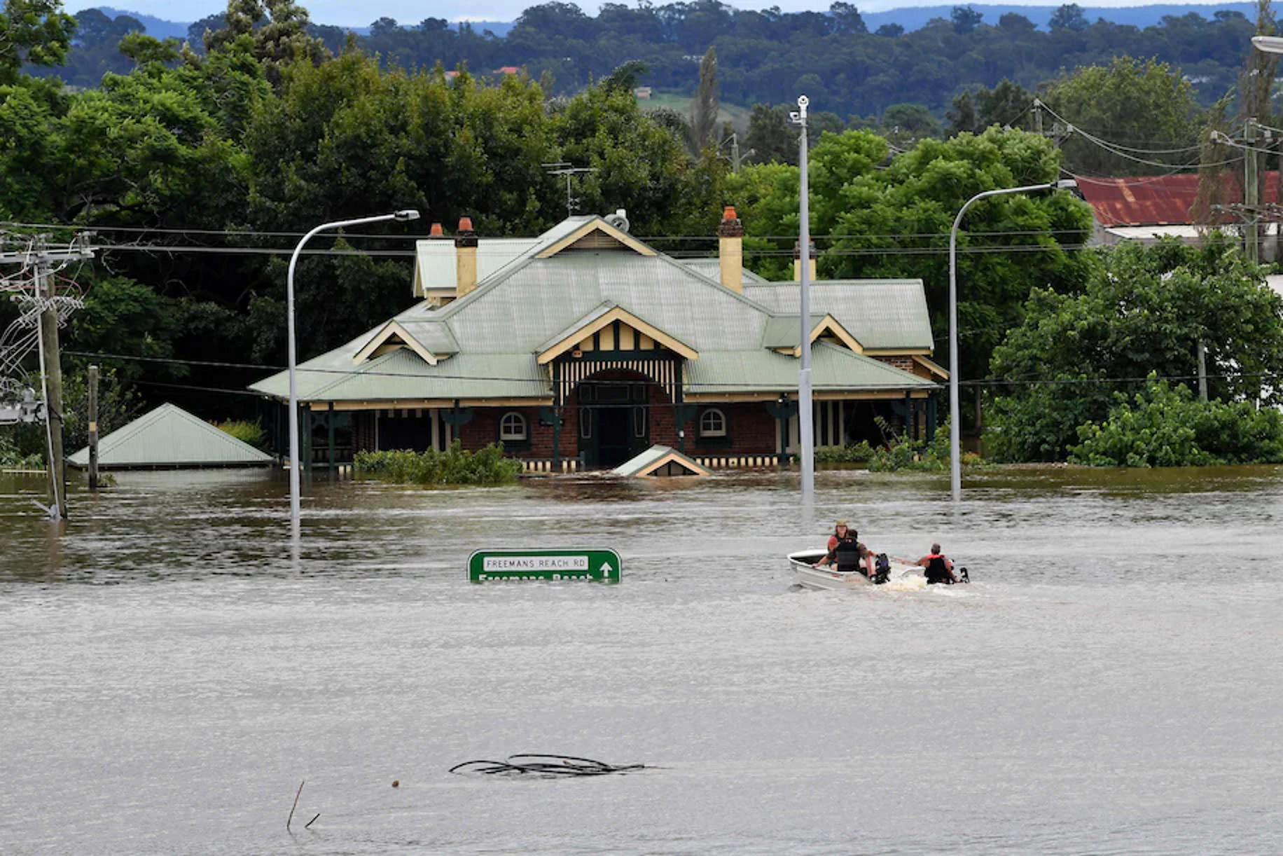 Boaters traverse floodwaters along the Hawkesbury River in Windsor, a suburb of Sydney, Australia, on 9 March 2022. Photo: Saeed Khan / AFP / Getty Images