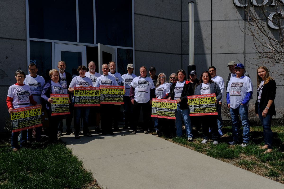 Anti-solar supporters pose for a portrait at the Johnson County BOCC public hearing on the solar amendments recommended by the Planning Commission in Olathe, Kansas, U.S., 4 April 2022. Photo: Arin Yoon / REUTERS